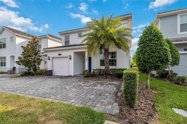 4740 Sleepy Hollow Dr, Kissimmee, FL 34746 - view of front facade featuring stucco siding, decorative driveway, a garage, and a tiled roof