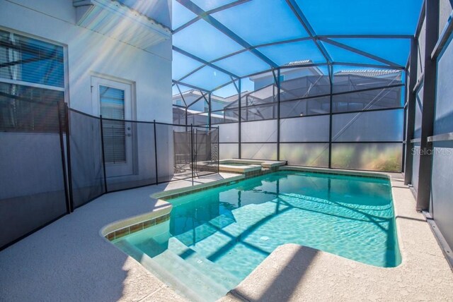 4740 Sleepy Hollow Dr, Kissimmee, FL 34746 - view of pool featuring a patio area, a pool with connected hot tub, and glass enclosure