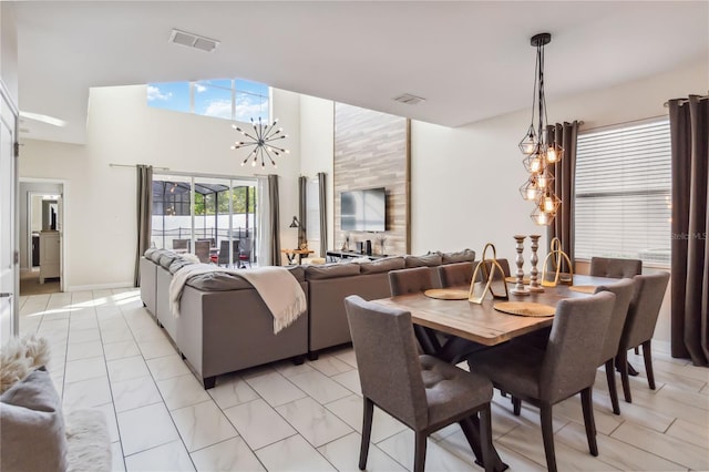 4740 Sleepy Hollow Dr, Kissimmee, FL 34746 - dining area with a chandelier, a high ceiling, and light marble finish flooring