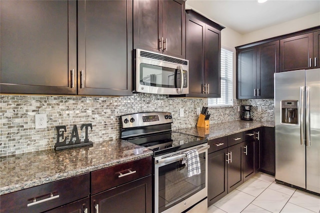 4740 Sleepy Hollow Dr, Kissimmee, FL 34746 - kitchen featuring stainless steel appliances, dark stone countertops, and tasteful backsplash