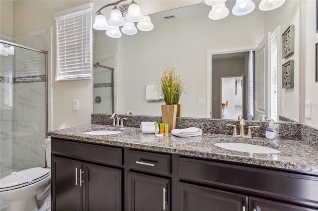 4740 Sleepy Hollow Dr, Kissimmee, FL 34746 - bathroom with a chandelier, double vanity, a stall shower, and toilet