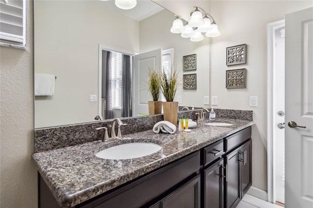 4740 Sleepy Hollow Dr, Kissimmee, FL 34746 - full bath featuring double vanity, a chandelier, and baseboards