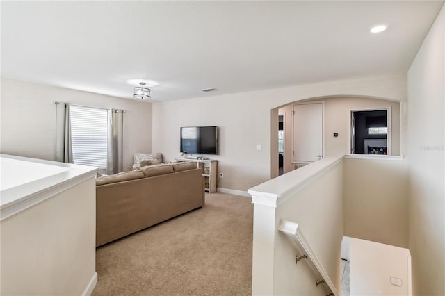 4740 Sleepy Hollow Dr, Kissimmee, FL 34746 - living area with arched walkways, light carpet, and baseboards