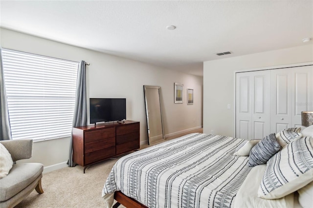 4740 Sleepy Hollow Dr, Kissimmee, FL 34746 - bedroom featuring a closet, light carpet, and baseboards