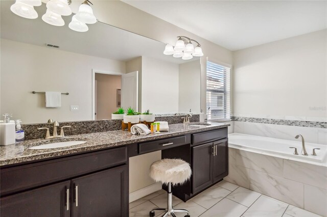 4740 Sleepy Hollow Dr, Kissimmee, FL 34746 - full bathroom with a chandelier, double vanity, a garden tub, and marble finish flooring