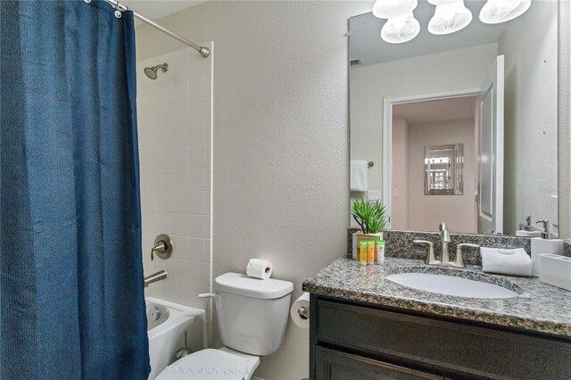 4740 Sleepy Hollow Dr, Kissimmee, FL 34746 - bathroom featuring vanity, shower / bathtub combination with curtain, toilet, and a textured wall