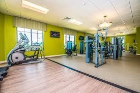 4740 Sleepy Hollow Dr, Kissimmee, FL 34746 - exercise room featuring baseboards and wood finished floors