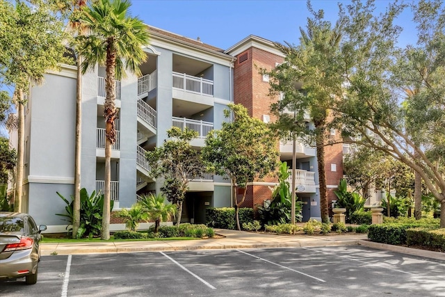 1100 Sunset View Cir Unit 204, Reunion, FL 34747 - view of apartment building / complex featuring uncovered parking