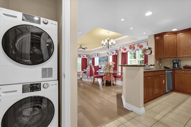 1100 Sunset View Cir Unit 204, Reunion, FL 34747 - laundry room featuring stacked washer and clothes dryer, a chandelier, recessed lighting, light tile patterned floors, and a ceiling fan