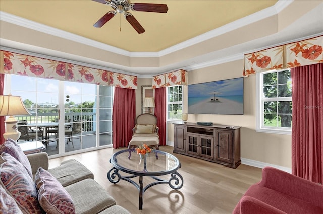 1100 Sunset View Cir Unit 204, Reunion, FL 34747 - living room featuring a raised ceiling, crown molding, wood finished floors, ceiling fan, and baseboards