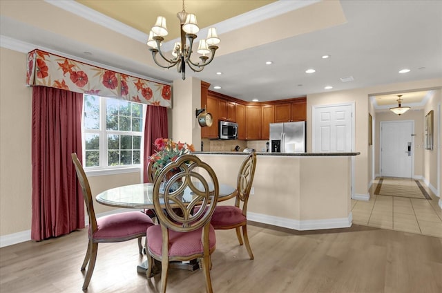 1100 Sunset View Cir Unit 204, Reunion, FL 34747 - dining area with a chandelier, baseboards, ornamental molding, light wood-style flooring, and recessed lighting