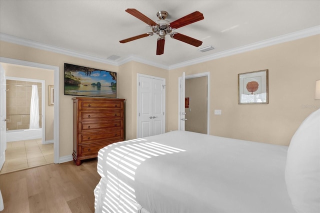 1100 Sunset View Cir Unit 204, Reunion, FL 34747 - bedroom with ornamental molding, light wood finished floors, baseboards, connected bathroom, and ceiling fan