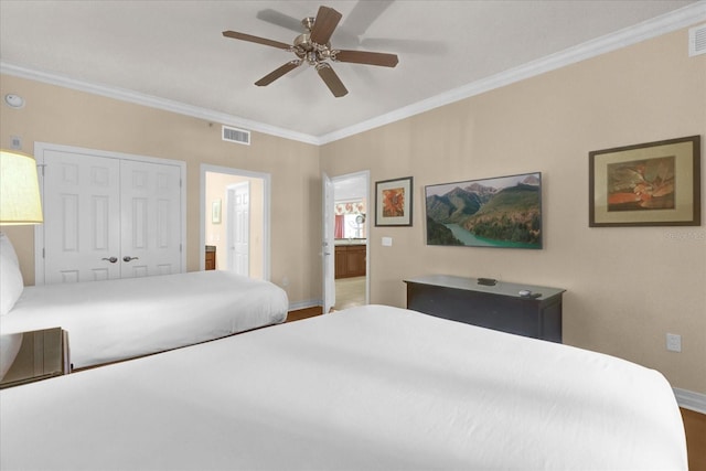 1100 Sunset View Cir Unit 204, Reunion, FL 34747 - bedroom with ornamental molding, baseboards, a closet, wood finished floors, and a ceiling fan