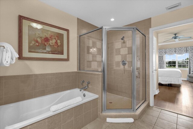 1100 Sunset View Cir Unit 204, Reunion, FL 34747 - ensuite bathroom featuring a bath, a stall shower, tile patterned floors, ceiling fan, and recessed lighting