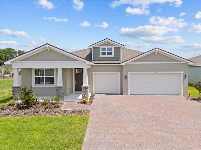 2639 Ginseng Ivy St, Apopka, FL 32703 - craftsman house with decorative driveway, a garage, stucco siding, roof with shingles, and a front lawn