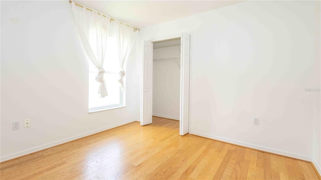 4236 Newtonhall Dr, Orlando, FL 32826 - unfurnished bedroom with light wood finished floors, baseboards, and a closet
