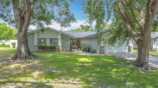 620 Wood Dr, Kissimmee, FL 34759 - view of front of property with an attached garage, concrete driveway, stucco siding, and a front yard