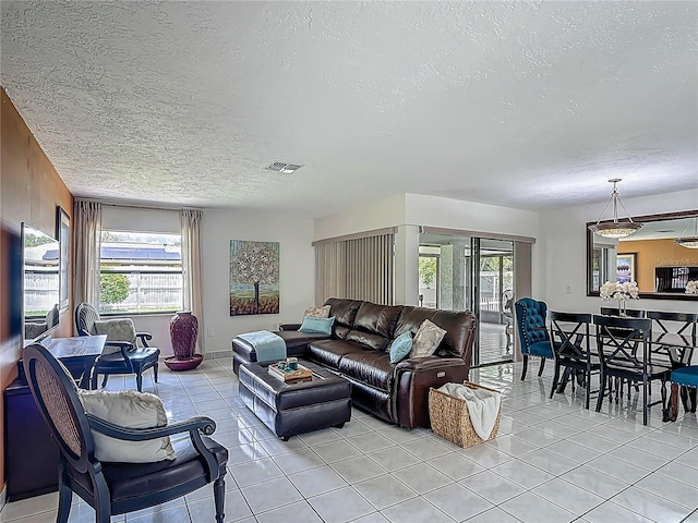 620 Wood Dr, Kissimmee, FL 34759 - living room featuring a textured ceiling and light tile patterned floors