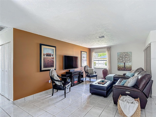 620 Wood Dr, Kissimmee, FL 34759 - living room with a textured ceiling and light tile patterned floors