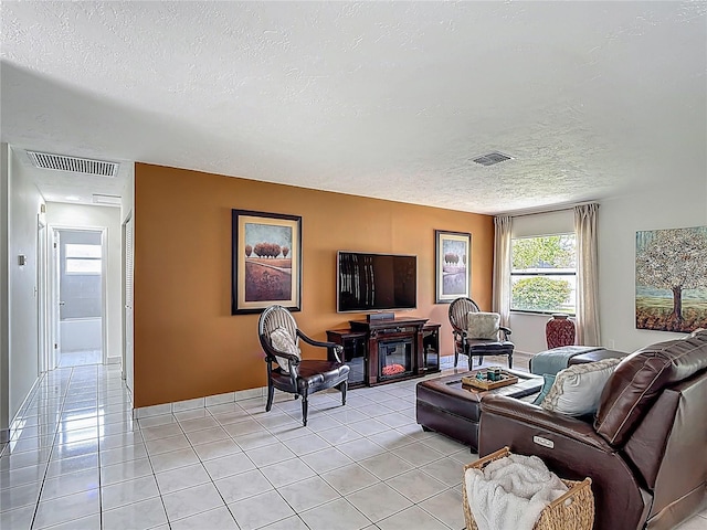 620 Wood Dr, Kissimmee, FL 34759 - living area featuring a textured ceiling and light tile patterned floors
