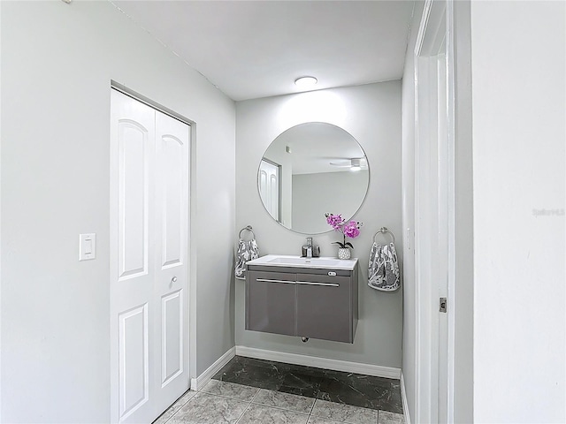 620 Wood Dr, Kissimmee, FL 34759 - bathroom featuring baseboards, marble finish floors, and vanity