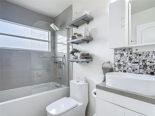 620 Wood Dr, Kissimmee, FL 34759 - full bath with toilet, shower / bathtub combination, vanity, and tasteful backsplash