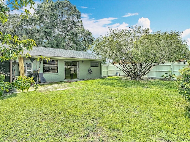 620 Wood Dr, Kissimmee, FL 34759 - rear view of house with stucco siding