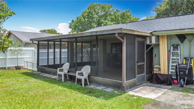 620 Wood Dr, Kissimmee, FL 34759 - rear view of house with a sunroom and roof with shingles