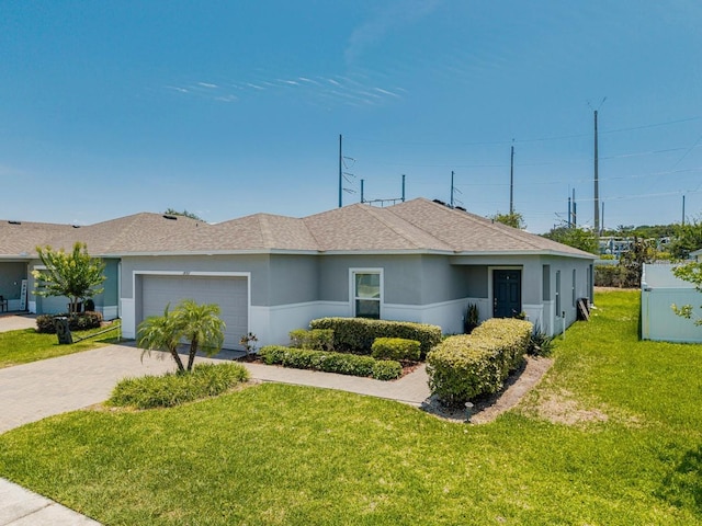 14357 Hidden Ct, Clermont, FL 34711 - ranch-style home with an attached garage, driveway, a front yard, a shingled roof, and stucco siding