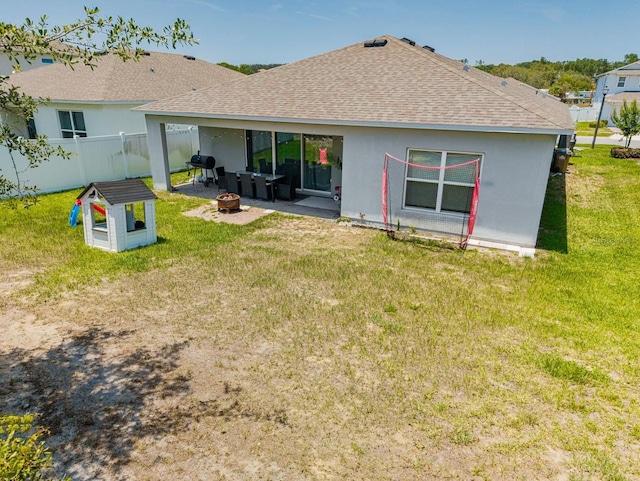 14357 Hidden Ct, Clermont, FL 34711 - rear view of house with an outdoor fire pit, a shingled roof, a patio, and stucco siding