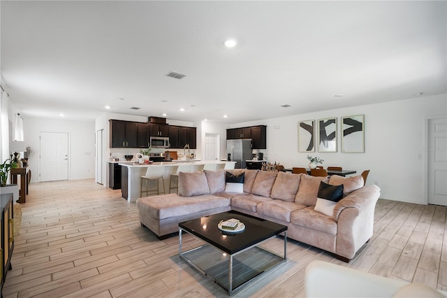 14357 Hidden Ct, Clermont, FL 34711 - living room featuring light wood-type flooring and recessed lighting
