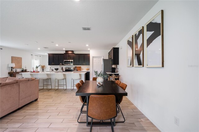 14357 Hidden Ct, Clermont, FL 34711 - dining area with wood tiled floors and recessed lighting