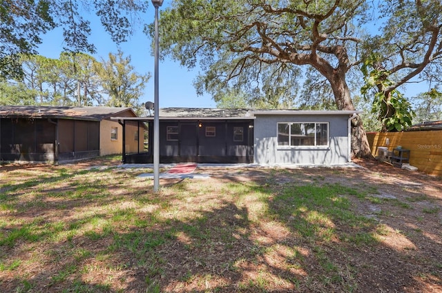 7214 Oakwood Dr, New Port Richey, FL 34652 - rear view of property with a sunroom