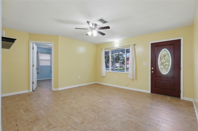 7214 Oakwood Dr, New Port Richey, FL 34652 - foyer entrance with ceiling fan, light wood-style floors, and baseboards