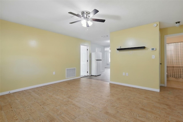 7214 Oakwood Dr, New Port Richey, FL 34652 - unfurnished living room with a ceiling fan, light wood-type flooring, and baseboards