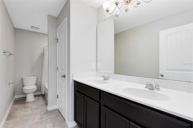 1978 J Lawson Blvd, Orlando, FL 32824 - bathroom with double vanity, baseboards, toilet, shower / tub combo, and stone finish flooring