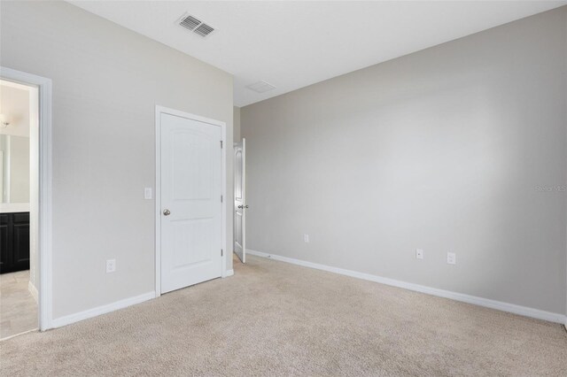 1978 J Lawson Blvd, Orlando, FL 32824 - unfurnished bedroom with light carpet, baseboards, and ensuite bathroom