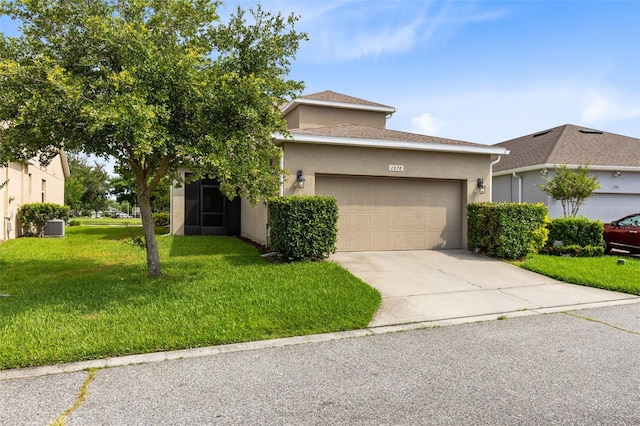 1978 J Lawson Blvd, Orlando, FL 32824 - view of front of home with an attached garage, a front yard, driveway, and stucco siding