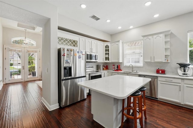 8418 Via Bella Notte, Orlando, FL 32836 - kitchen with stainless steel appliances, a sink, backsplash, a kitchen breakfast bar, and recessed lighting