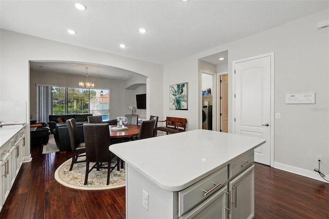 8418 Via Bella Notte, Orlando, FL 32836 - kitchen with dark wood-style flooring, arched walkways, a chandelier, light countertops, and recessed lighting