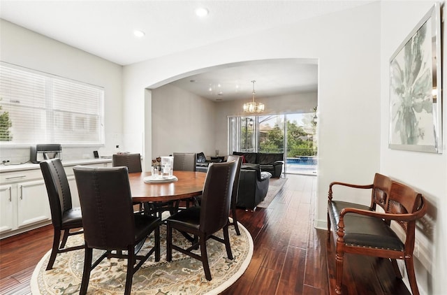 8418 Via Bella Notte, Orlando, FL 32836 - dining space featuring arched walkways, dark wood-type flooring, a chandelier, and recessed lighting
