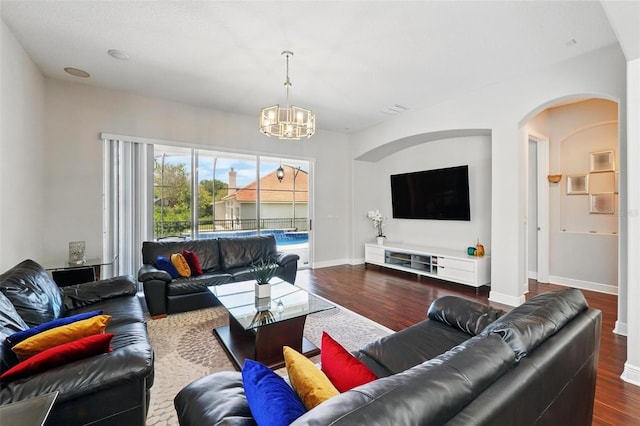 8418 Via Bella Notte, Orlando, FL 32836 - living room with arched walkways, a chandelier, wood finished floors, and baseboards