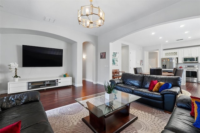 8418 Via Bella Notte, Orlando, FL 32836 - living area featuring arched walkways, dark wood-style flooring, a chandelier, baseboards, and recessed lighting