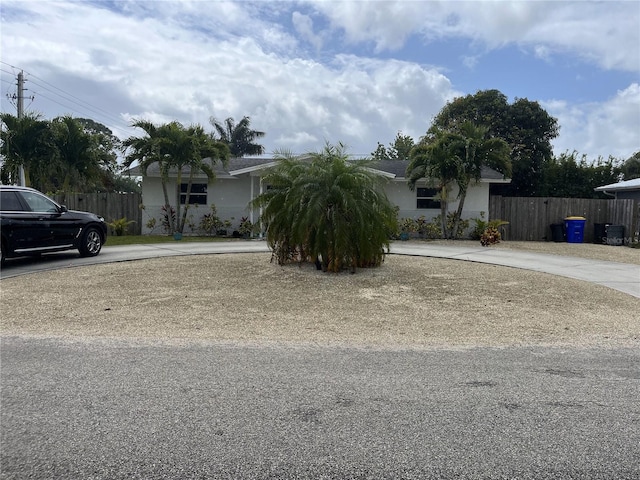 1894 SE Lafayette St, Stuart, FL 34997 - view of front facade featuring curved driveway and stucco siding