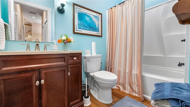 287 Hilltop Dr, Longwood, FL 32750 - bathroom featuring vanity, wood finished floors, toilet, and shower / bath combo with shower curtain