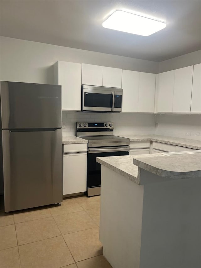 460 Sand Lime Rd, Winter Garden, FL 34787 - kitchen with appliances with stainless steel finishes, white cabinets, light countertops, and backsplash