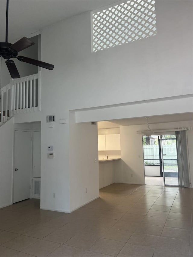 460 Sand Lime Rd, Winter Garden, FL 34787 - unfurnished living room with a towering ceiling, a ceiling fan, and light tile patterned flooring