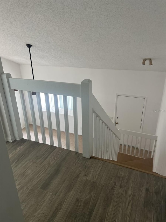 460 Sand Lime Rd, Winter Garden, FL 34787 - staircase with a textured ceiling and wood finished floors
