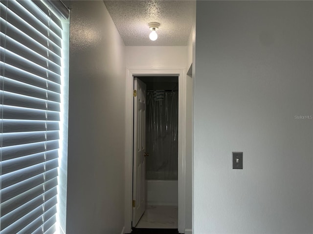 909 San Paulo Way, Kissimmee, FL 34758 - hall with a textured ceiling and marble look tiles