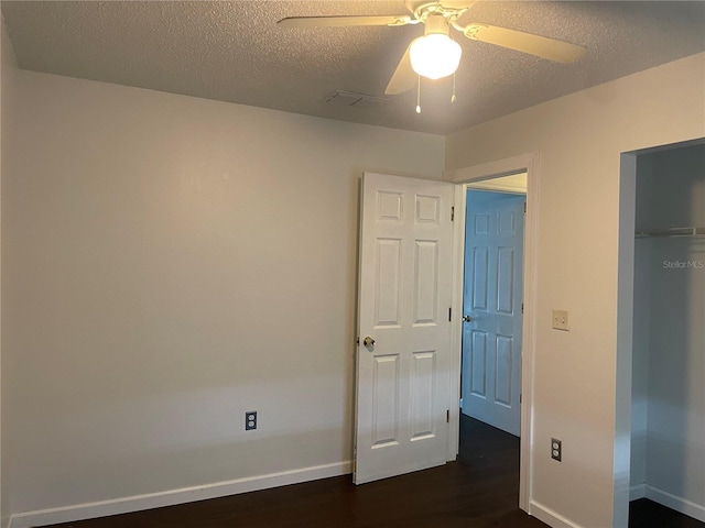 909 San Paulo Way, Kissimmee, FL 34758 - unfurnished bedroom with dark wood-style flooring, baseboards, a textured ceiling, and ceiling fan
